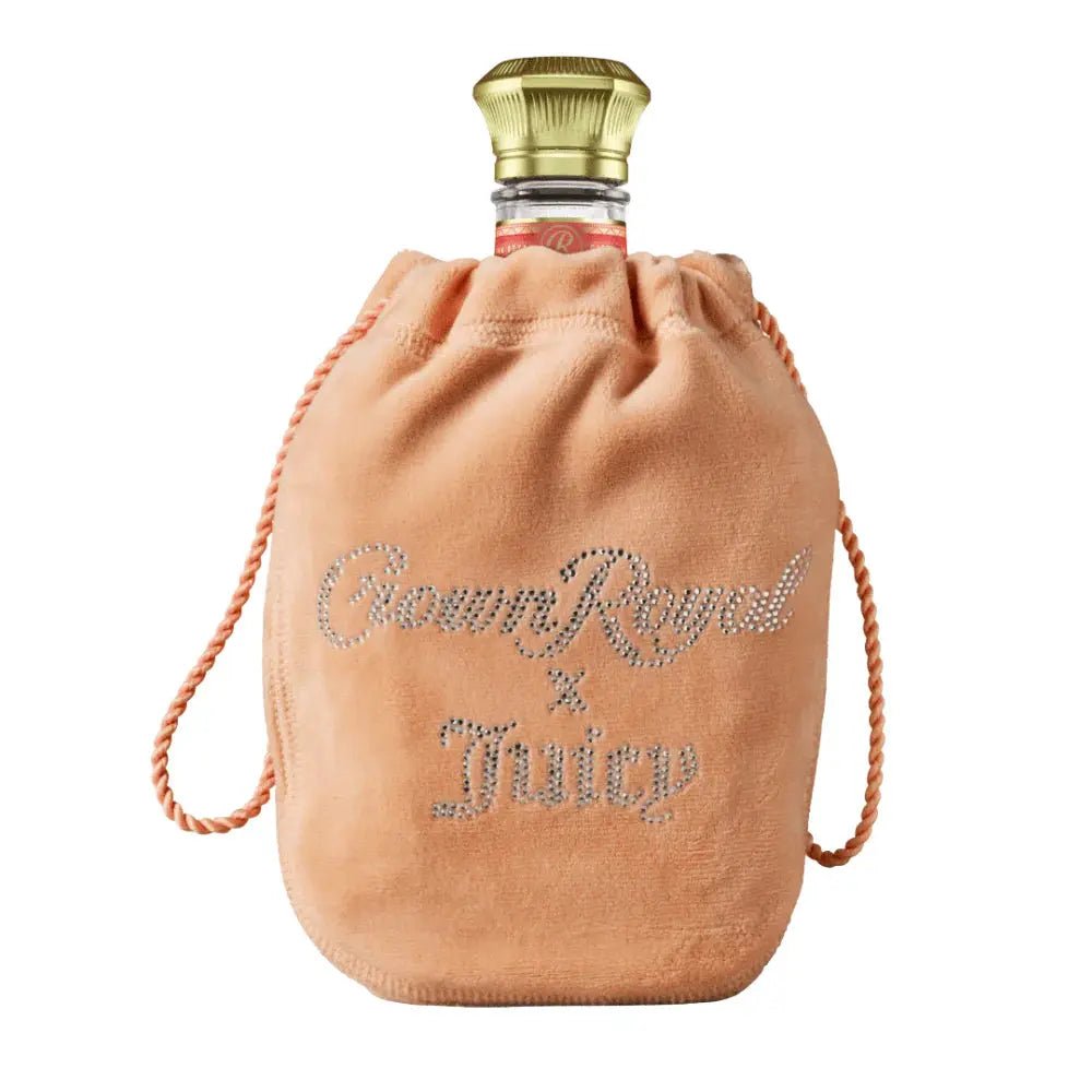 A bottle of Crown Royal Peach X Juicy Couture by Crown Royal, presented in a peach-colored suede bag adorned with "Crown Royal x Juicy" in rhinestones and showcasing the exclusive Juicy Couture limited edition design.