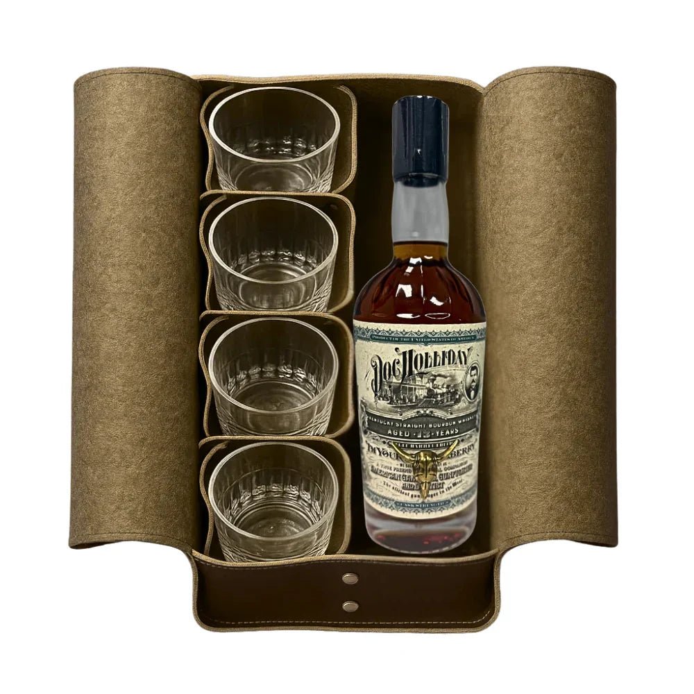 A brown leather case holds a bottle of Doc Holliday 13 Year Doctor's Bag Single Barrel Bourbon (Pre-Order) by Doc Holliday and four clear glass tumblers, all neatly arranged side by side.