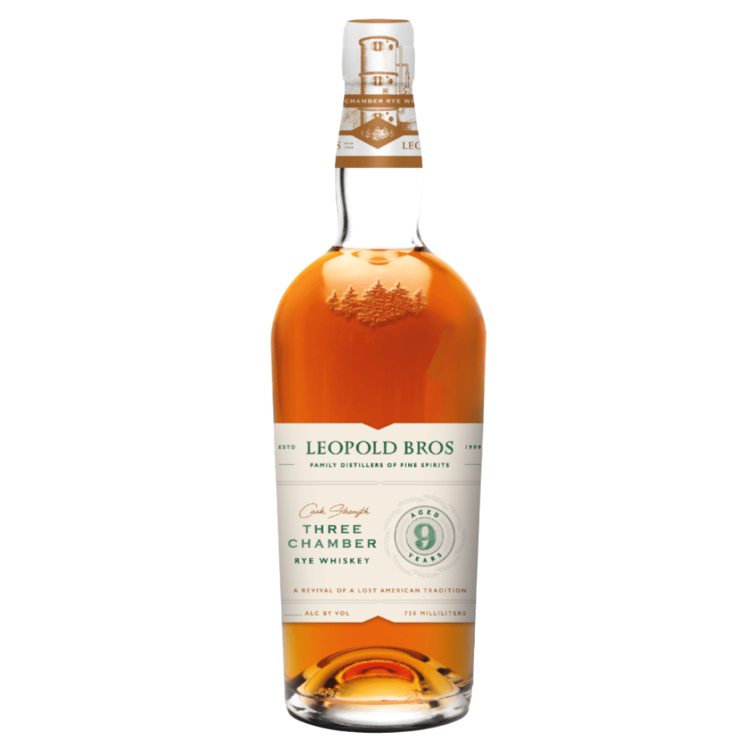 A bottle of Leopold Bros 9 Year Three Chamber Rye Whiskey Cask Strength Revival (PRE-ORDER) with amber liquid, white and green label, gold accents, a pine tree illustration, and “Three Chamber Rye Whiskey” highlighted for its 9-year aged rye heritage.