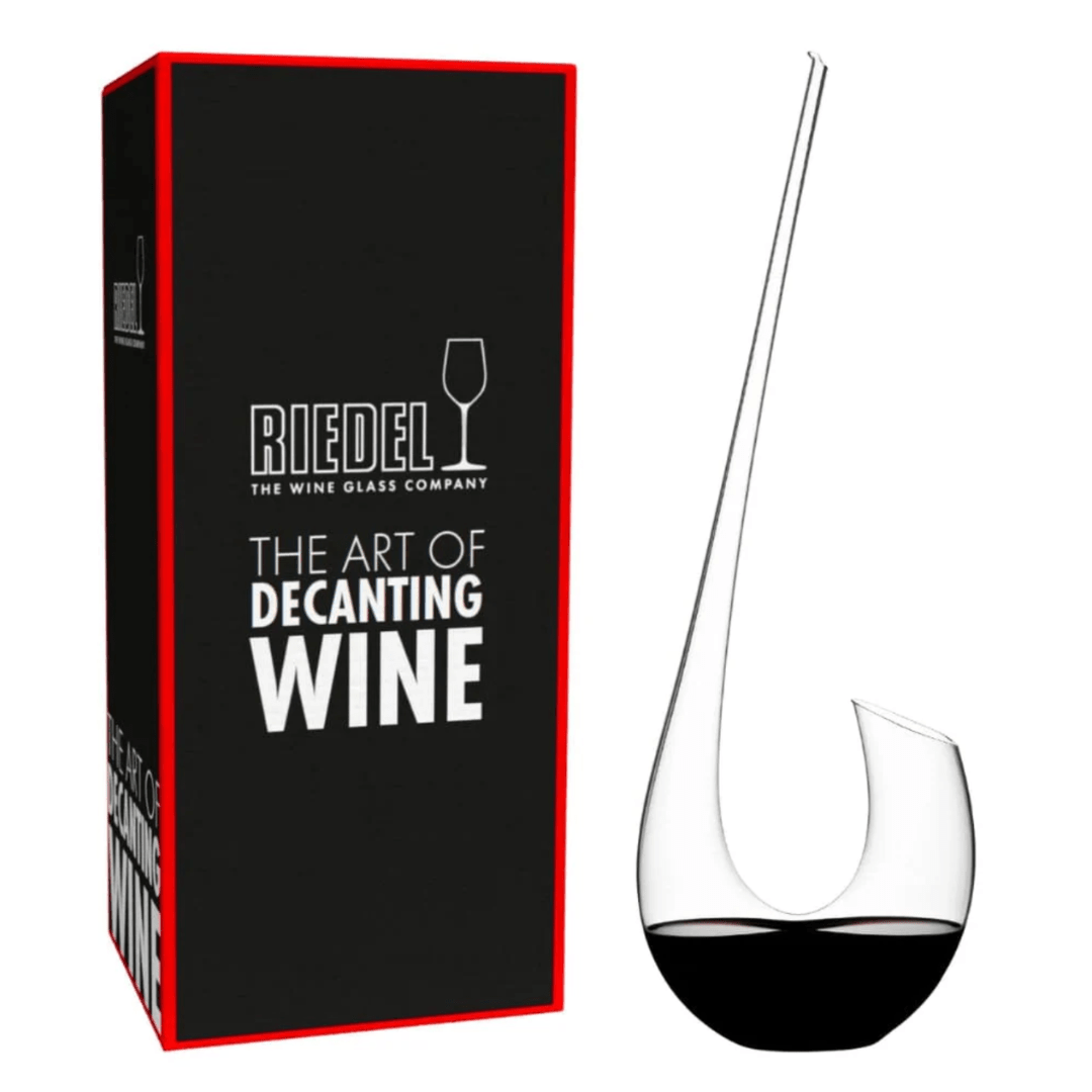 Displayed alongside its sleek black box bearing the phrase "Riedel The Art of Decanting Wine" in white lettering, the RIEDEL Wine Decanter Swan by Riedel features a graceful, curved crystal design that enhances wine aeration and brings an air of sophistication to any table setting.