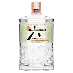 A clear, hexagonal glass bottle of Suntory Roku Gin Minori Select Edition, limited edition Japanese gin, with decorative embossing, a white label with Japanese characters and botanicals, and a wooden cap topped by a red seal.