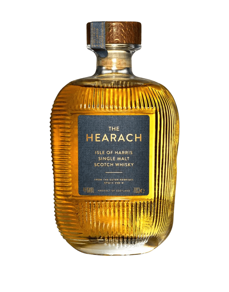 A bottle of The Hearach Isle of Harris Single Malt Scotch Whisky by The Hearach, featuring a ribbed glass design and a blue and copper label.