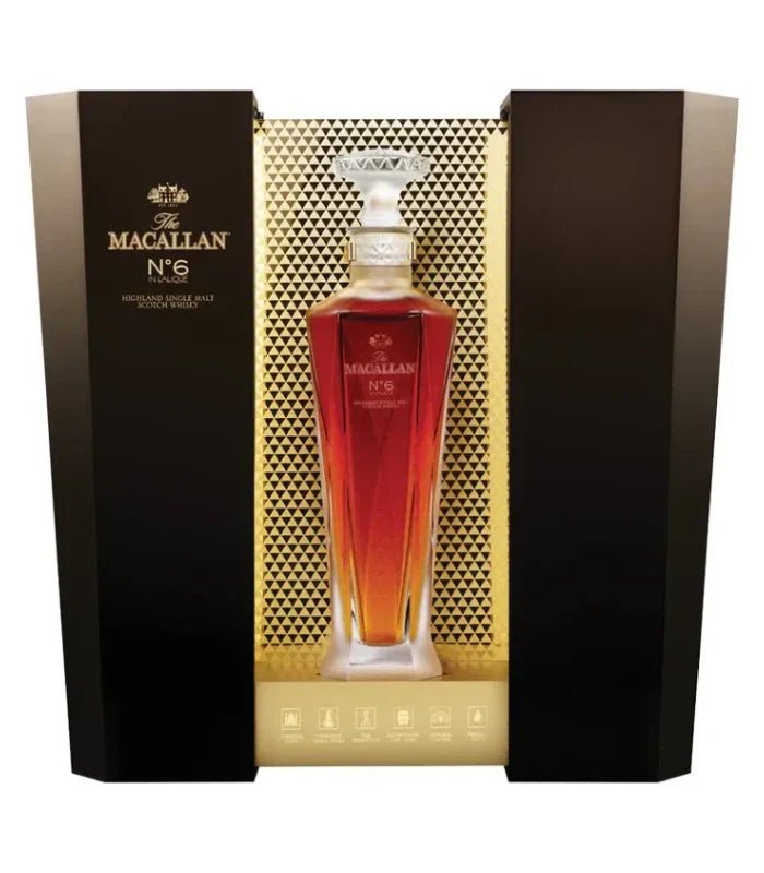 A bottle of The Macallan No. 6 Lalique Single Malt Scotch Whiskey by The Macallan, presented in a luxury crystal decanter and displayed in an elegant black and gold box with geometric patterns.