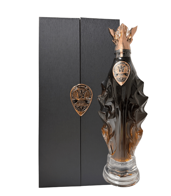 The World Whisky Society Masterfully Crafted 15 Year Ex-Buffalo Trace Kentucky Bourbon 130.6 Proof comes in a unique dark glass bottle with bronze accents, a dragon-themed cap, and a crest, paired with a tall black box featuring a bronze emblem.