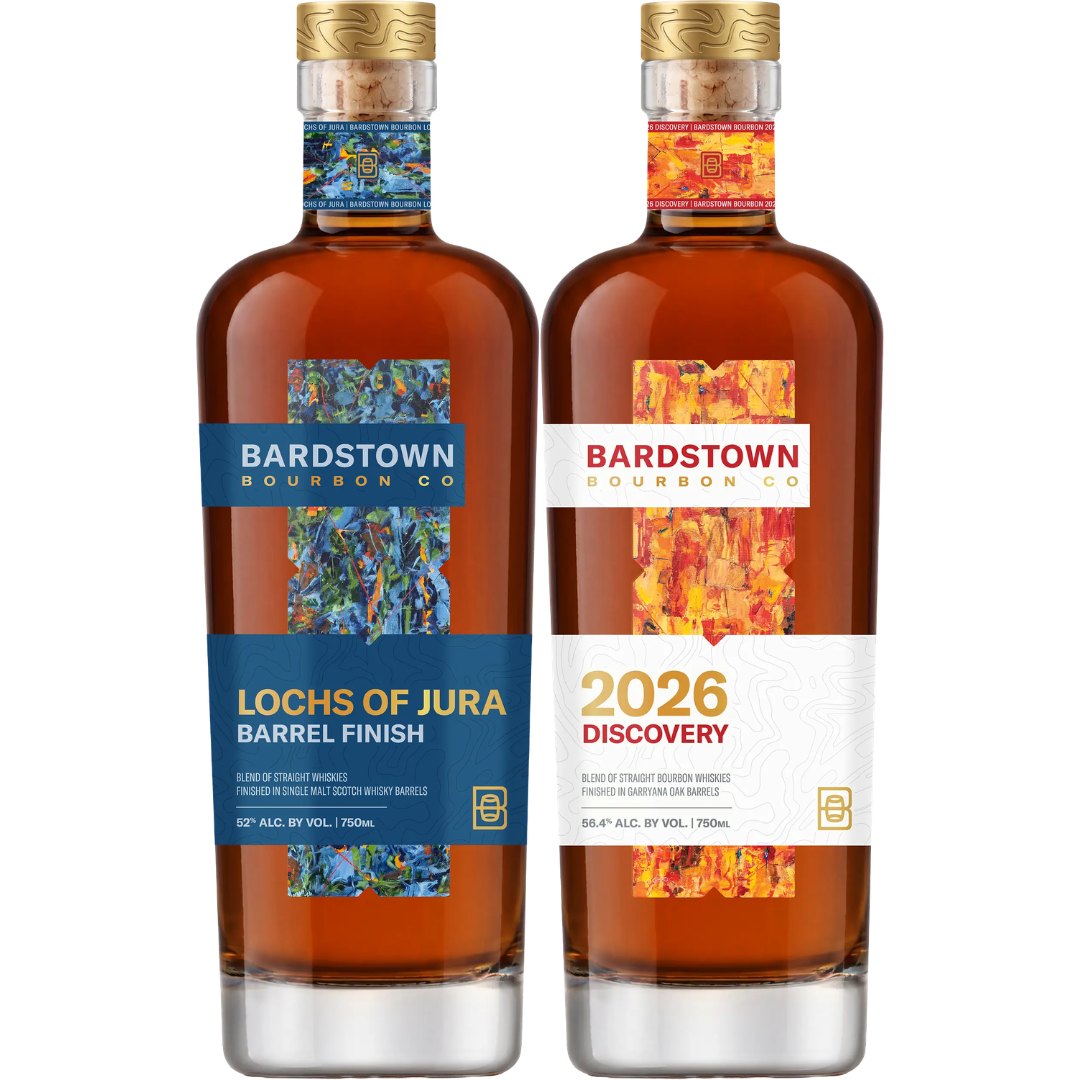 Two Bardstown Bourbon Company bottles from the Limited 2026 Bundle—Lochs of Jura and Discovery Garryana Oak Finish—stand side by side, each adorned with colorful vertical labels and elegant wooden caps: a striking display from Bardstown Bourbon Company.