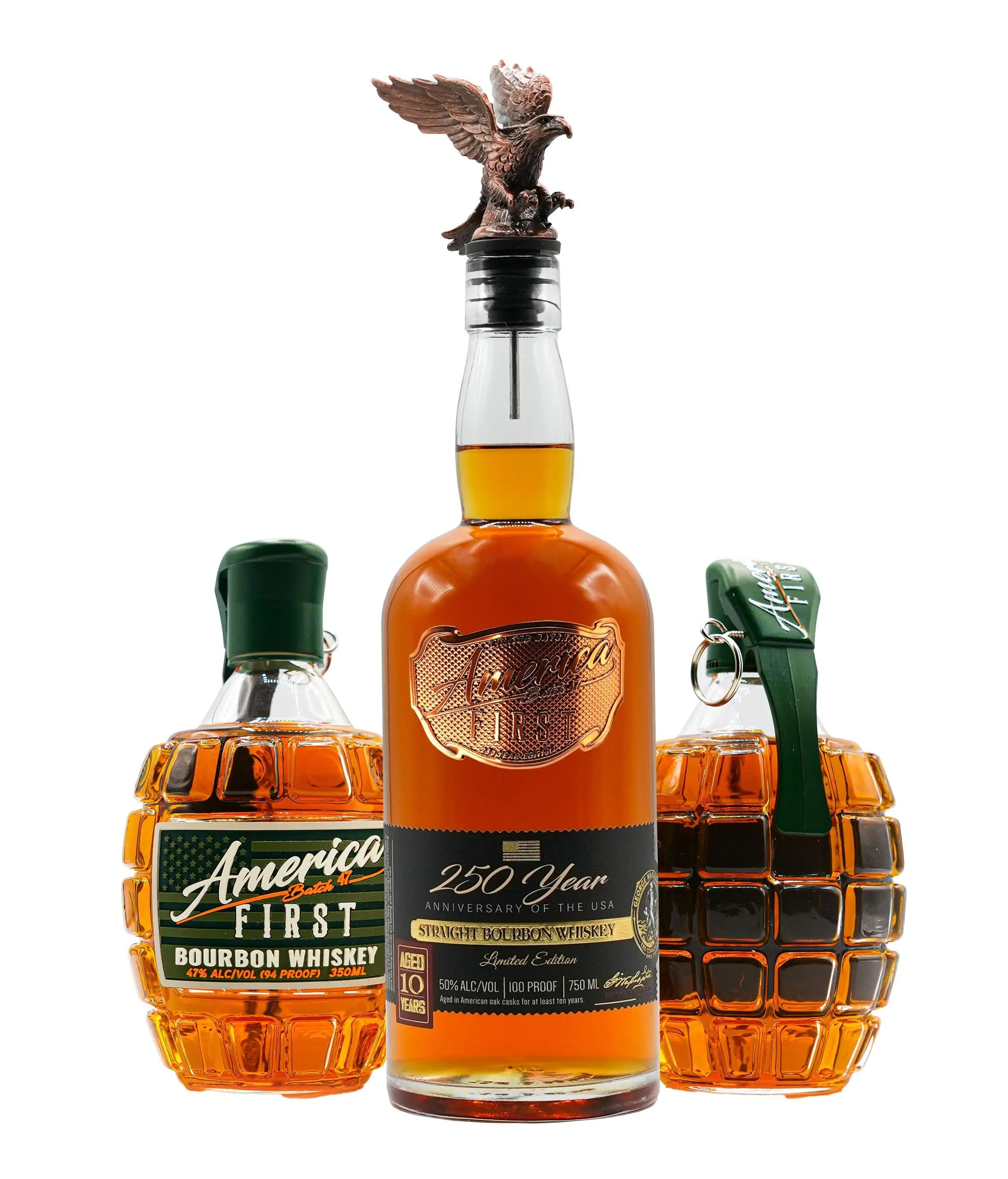 Three whiskey bottles: two America First Grenade Whiskey Bottles, labeled “America First Bourbon Whiskey,” flank a central America First 250th Anniversary Bourbon bottle with an eagle stopper. All bottles, part of the America First Limited Edition Bourbon Bundle, contain amber liquid.