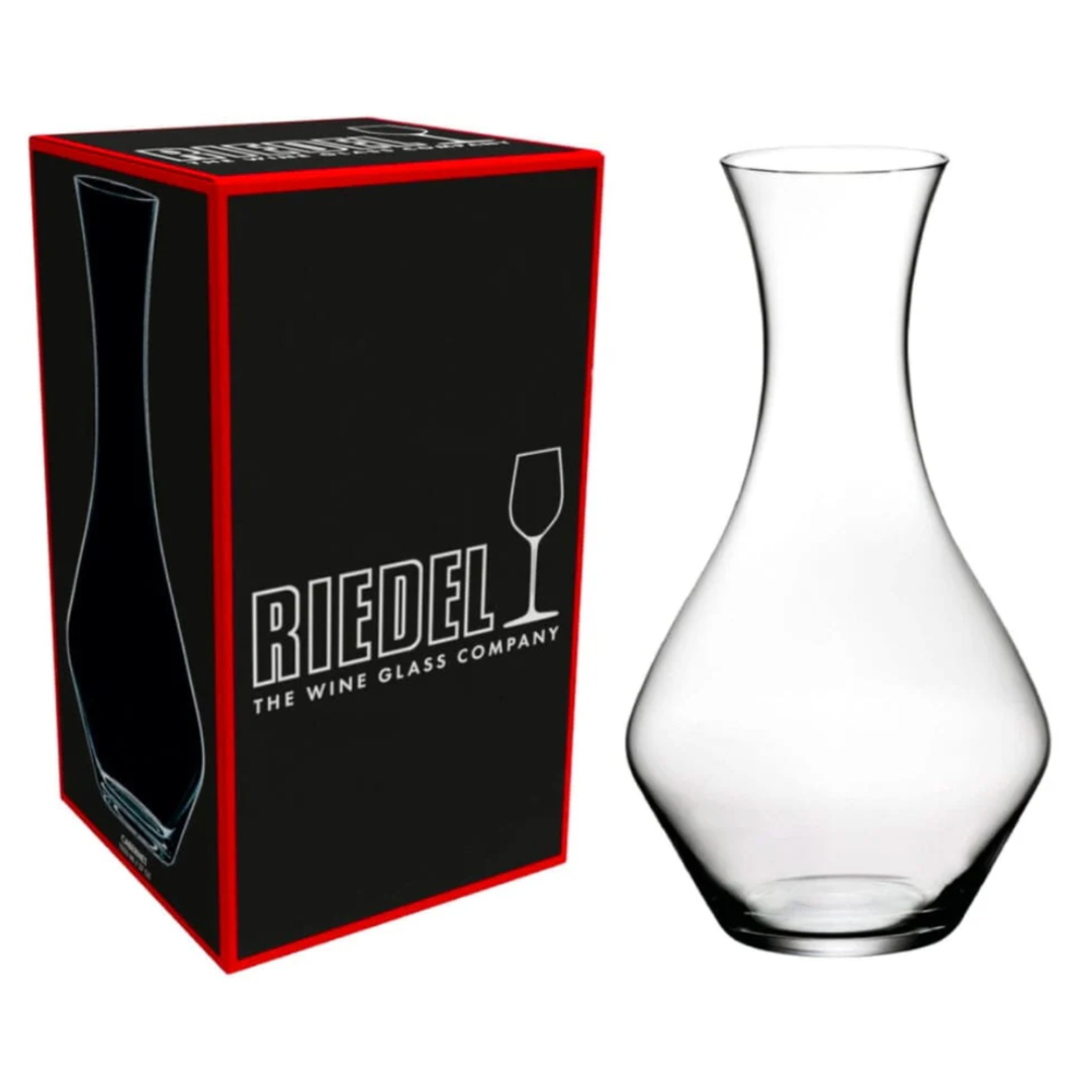 The RIEDEL Wine Decanter Cabernet Sauvignon by Riedel is displayed beside its black and red box, which features the brand’s logo and a wine glass icon—an elegant choice for serving Cabernet Sauvignon.