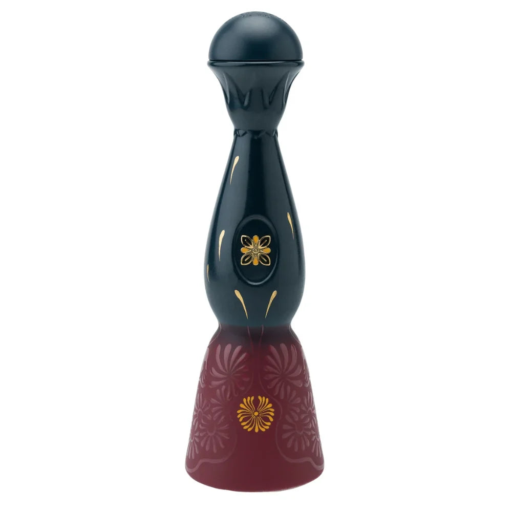 A dark, bell-shaped Clase Azul Día de Muertos Trascender 2026 Limited Edition Añejo Tequila 1L decanter with a round stopper, featuring gold floral accents on the neck and a base with deep red engraved floral patterns.