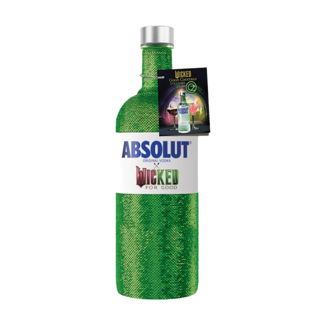 A bottle of Absolut Vodka’s Absolut X Wicked Limited Edition, wrapped in shimmering green fabric, features a "Wicked For Good" label and includes a card with Wicked-themed cocktail recipes.
