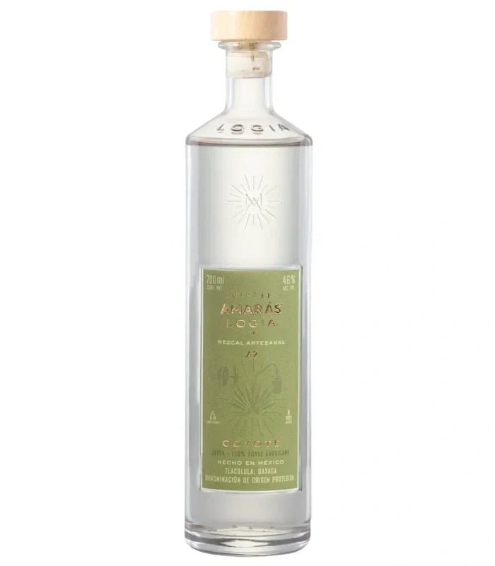 A clear 700mL glass bottle of Amaras Mezcal Joven Logia Ma Coyote A2, featuring a light wooden cap and green label with agave illustrations, contains 46% alcohol.