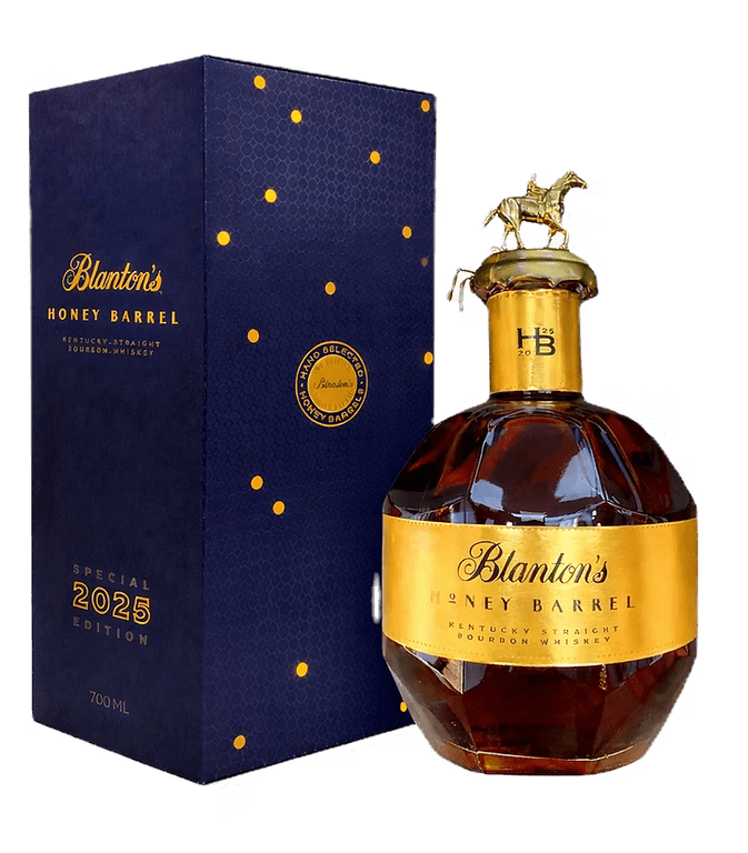 A bottle of Blanton's Honey Barrel Bourbon 2025 Special Release 700mL with a gold label and horse stopper sits next to its blue and gold special edition box.