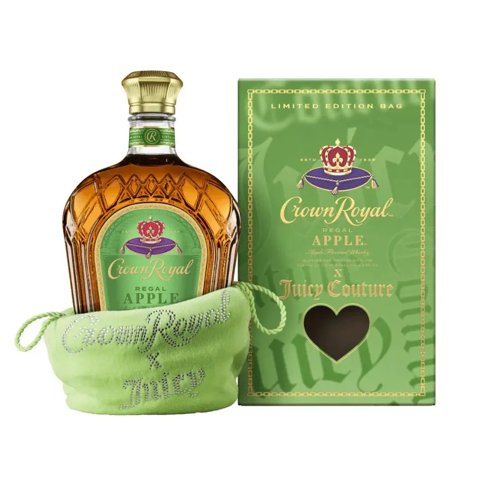 A bottle of Crown Royal Regal Apple x Juicy Couture Limited Edition by Crown Royal, featuring apple flavored whisky in a green bag, sits beside the matching limited edition Juicy Couture box with a heart-shaped cutout.