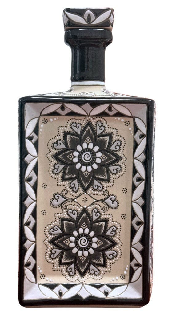 A hand-painted rectangular ceramic decanter with a black stopper, featuring intricate black and white floral mandala and geometric designs on beige, perfect for displaying Dos Artes Extra Añejo Reserva Especial 1L Tequila by Dos Artes.