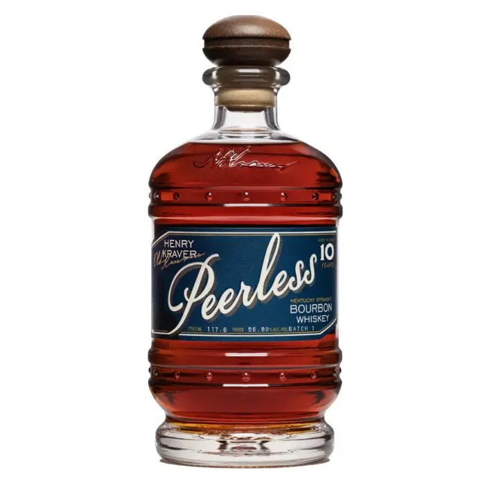 A clear glass bottle of Kentucky Peerless Henry Kraver’s Old Reserve 10 Year Bourbon features a wooden-topped cork and a dark blue label with gold and white text. The amber Kentucky Peerless bourbon is visible inside.