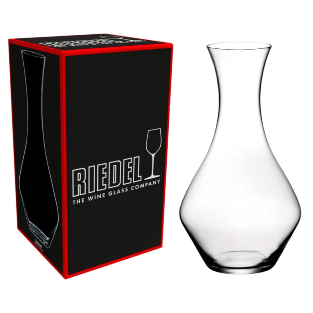 The RIEDEL Wine Decanter Cabernet Sauvignon by Riedel is displayed beside its black and red box, which features the brand’s logo and a wine glass icon—an elegant choice for serving Cabernet Sauvignon.